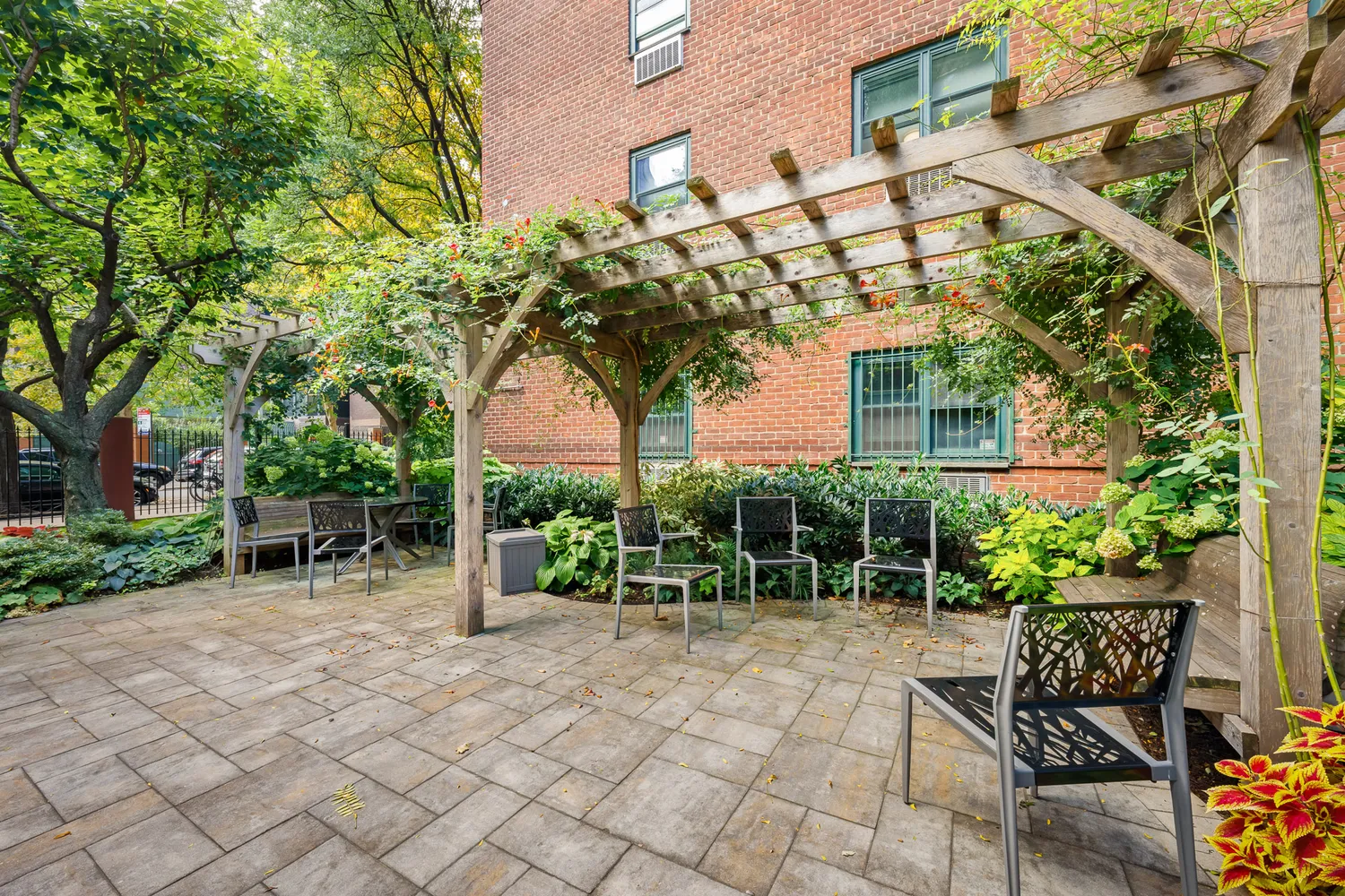 a backyard of a house with table and chairs