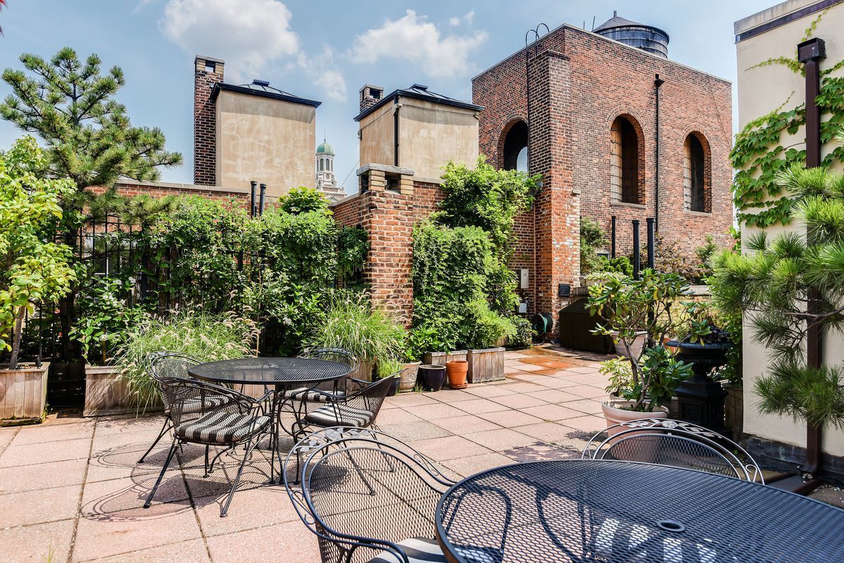 30 5th Avenue, Unit 16H Manhattan, NY 10011 - Photo 13 of 15 a patio with a table and chairs and potted plants