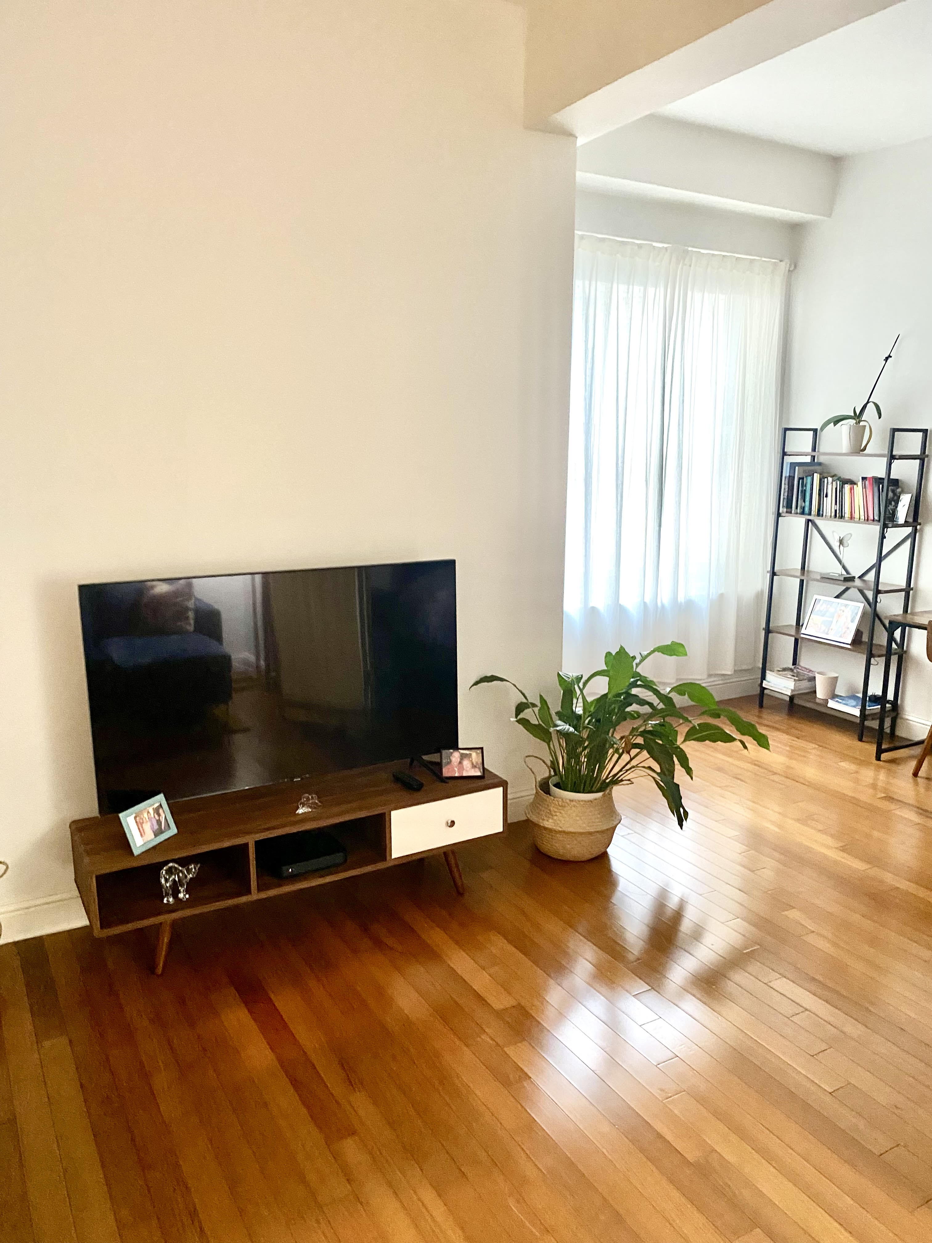 88 Greenwich Street, Unit 1218 Manhattan, NY 10006 - Photo 5 of 30 a living room with furniture and a flat screen tv