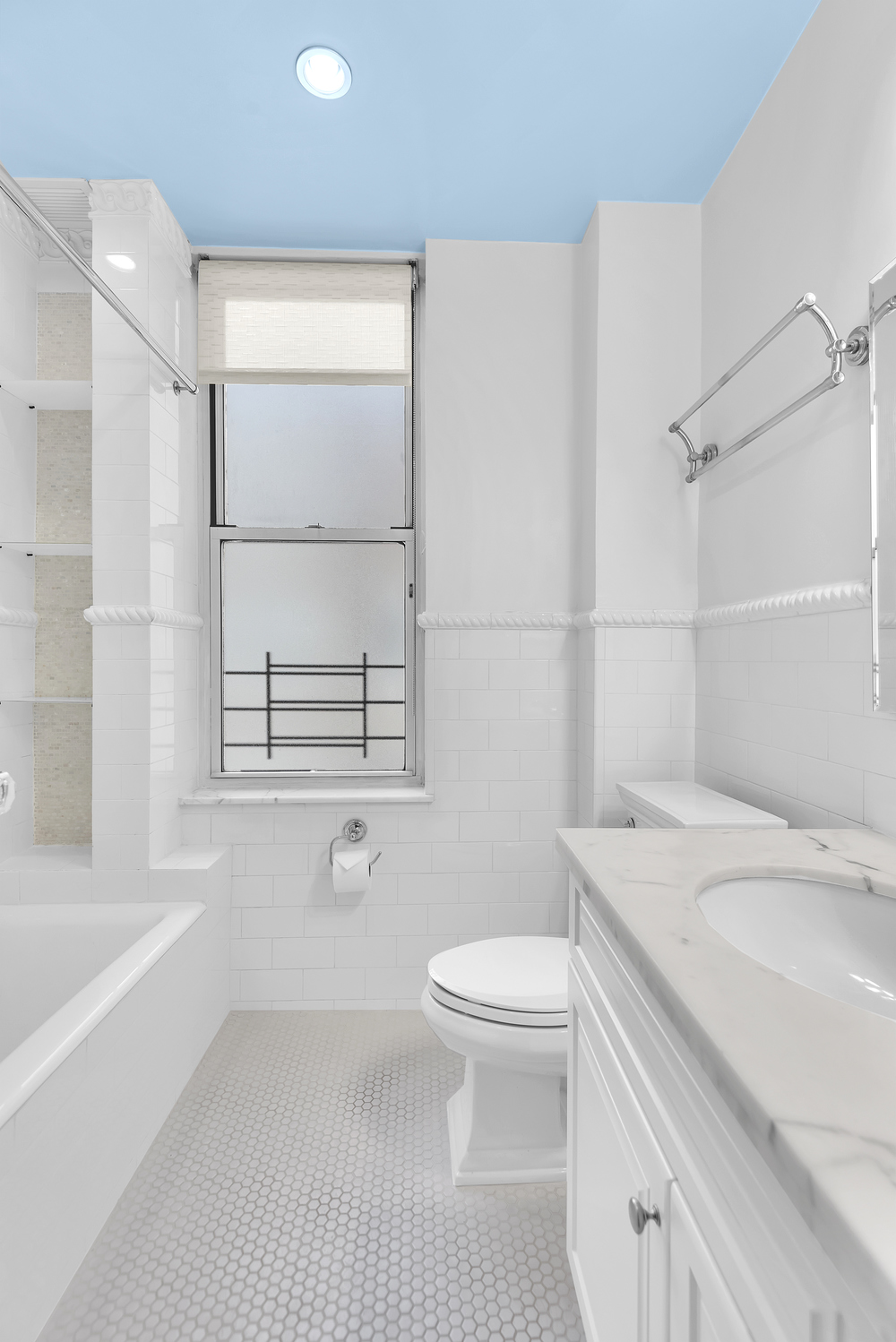 122 East 82nd Street, Unit 8C Manhattan, NY 10028 - Photo 12 of 15 a bathroom with a sink a toilet and shower