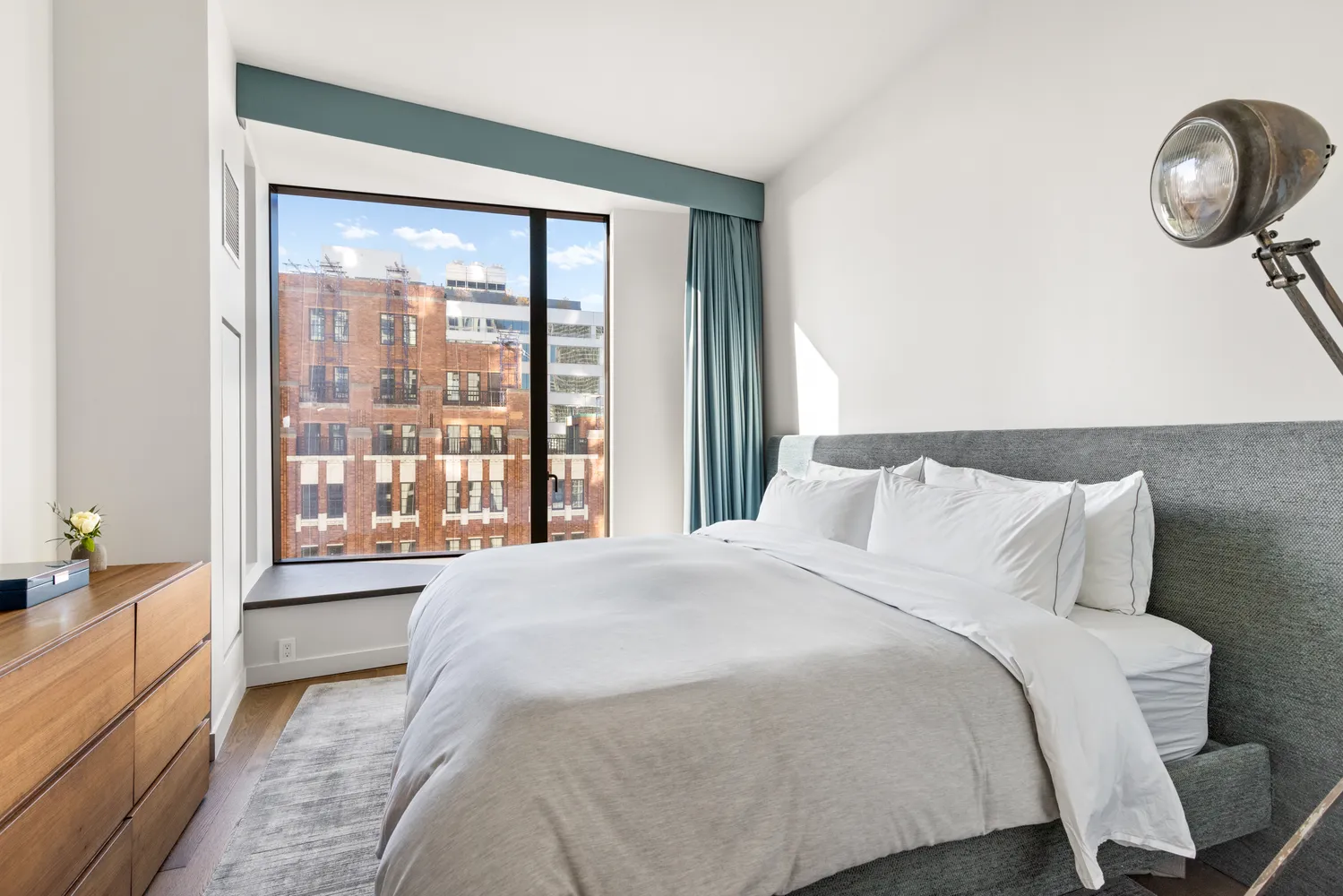 a bedroom with a bed and painting on the wall