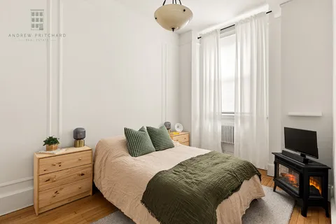 a bedroom with a bed and a flat tv screen