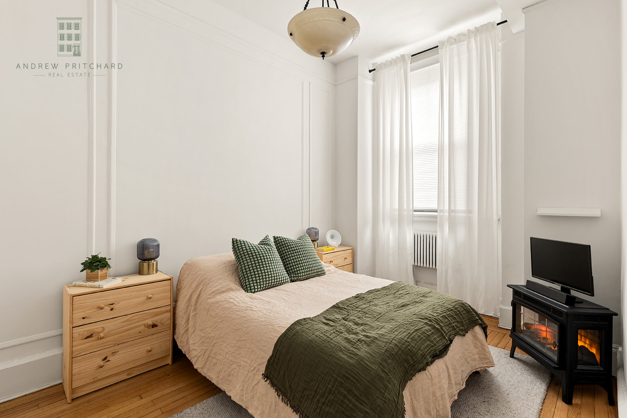 212 East 48th Street, Unit 1D Manhattan, NY 10017 - Photo 7 of 12 a bedroom with a bed and a flat tv screen