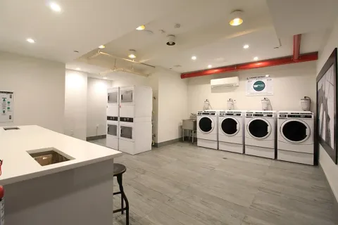 a kitchen with a stove a refrigerator and a microwave