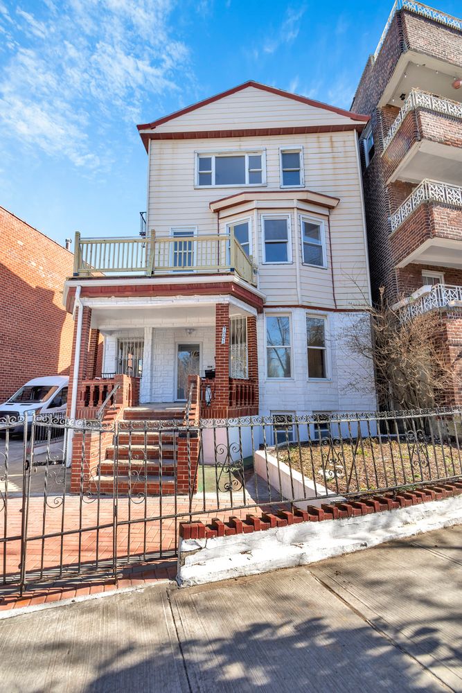 7001 Shore Road, Unit 2 Brooklyn, NY 11209 - Photo 16 of 17 a front view of a residential apartment building with a street