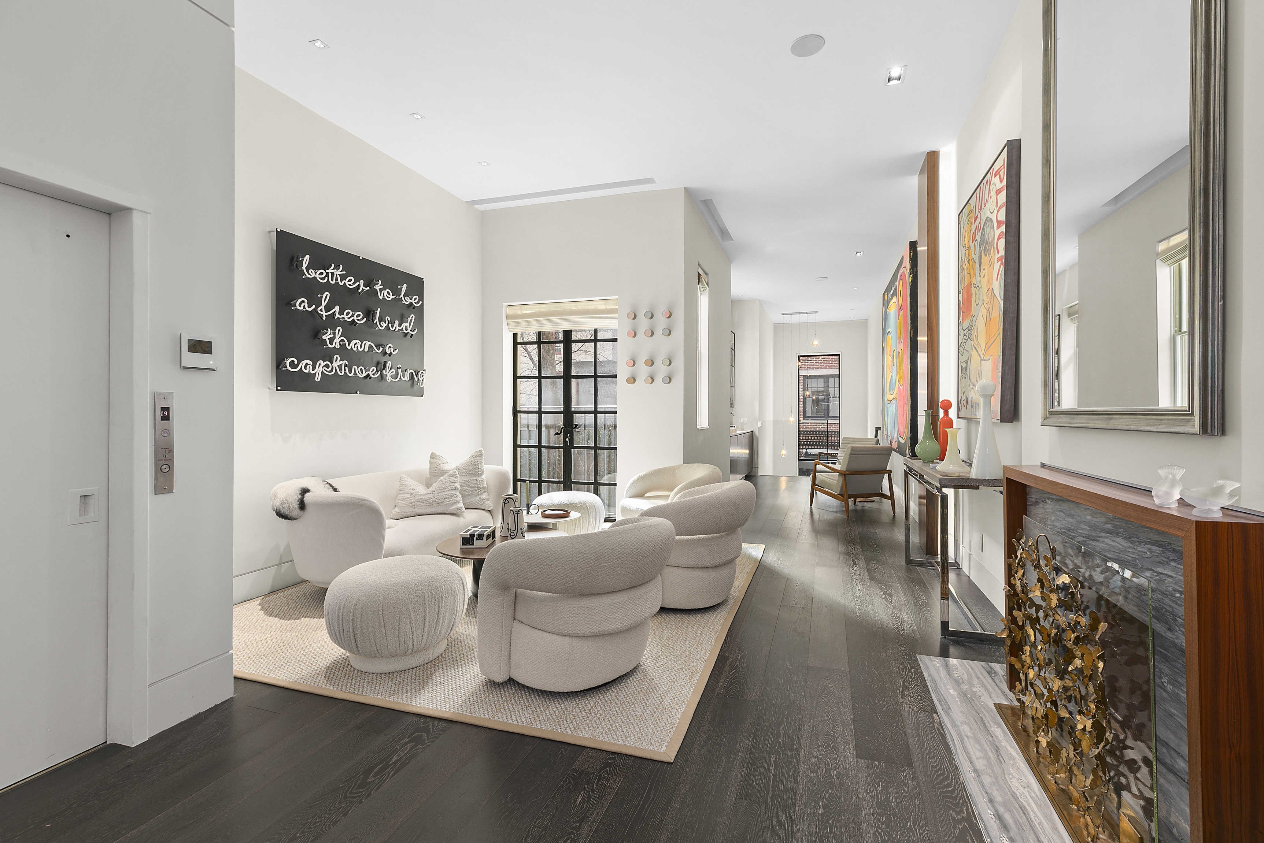 36 East 64th Street Manhattan, NY 10065 - Photo 4 of 27 a living room with furniture and a fireplace