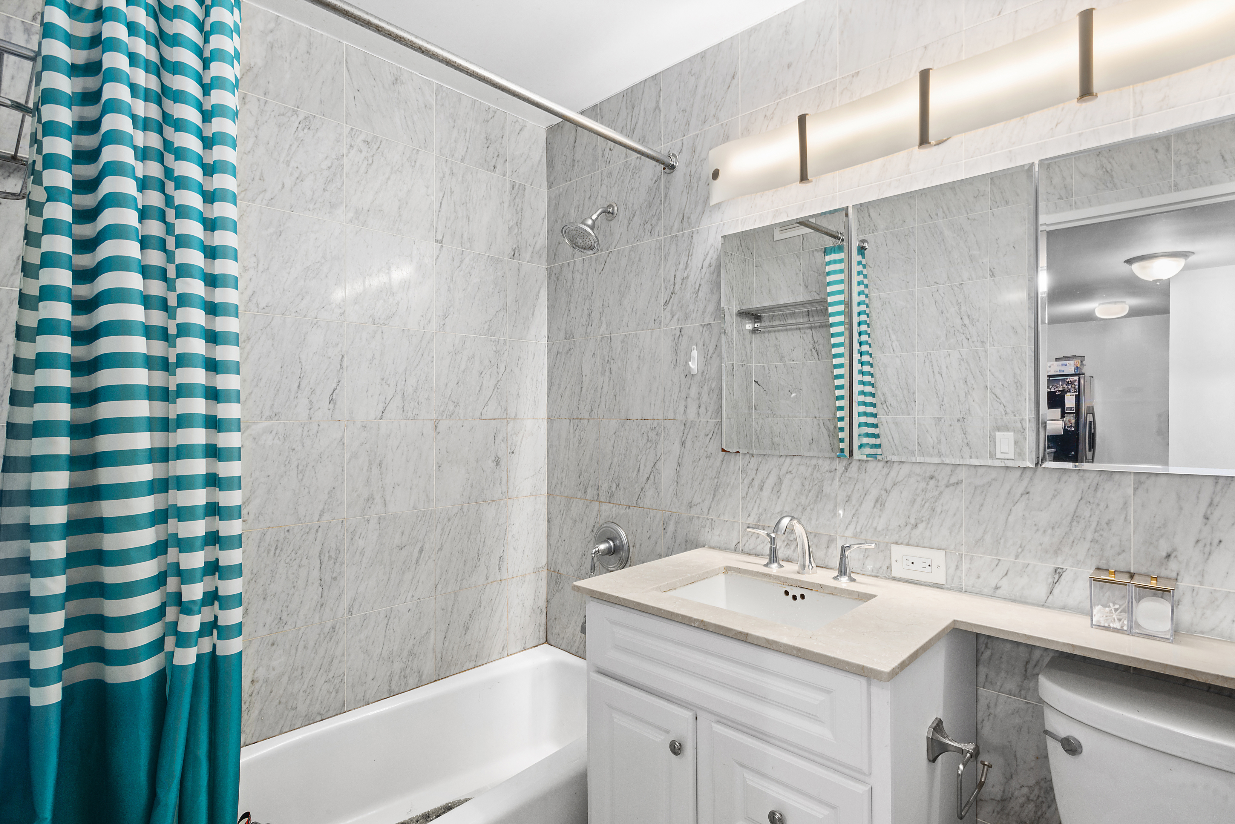 2 South End Avenue, Unit 9E Manhattan, NY 10280 - Photo 6 of 7 a bathroom with a sink and a mirror