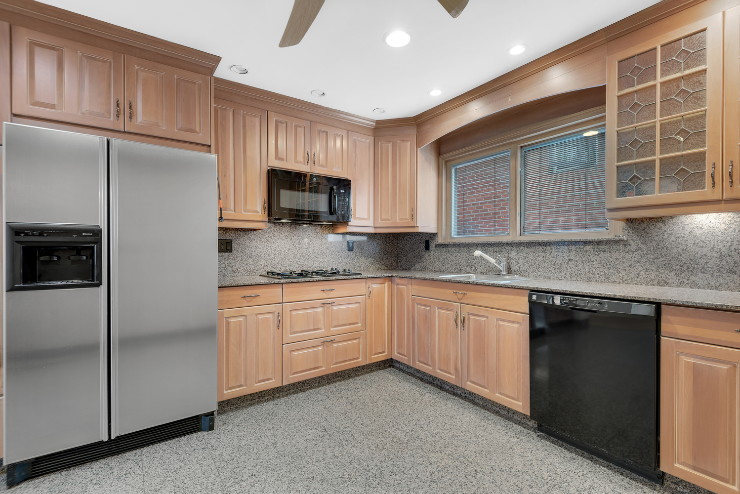95 83rd Street Brooklyn, NY 11209 - Photo 11 of 18 a kitchen with granite countertop stainless steel appliances a sink cabinets and a window