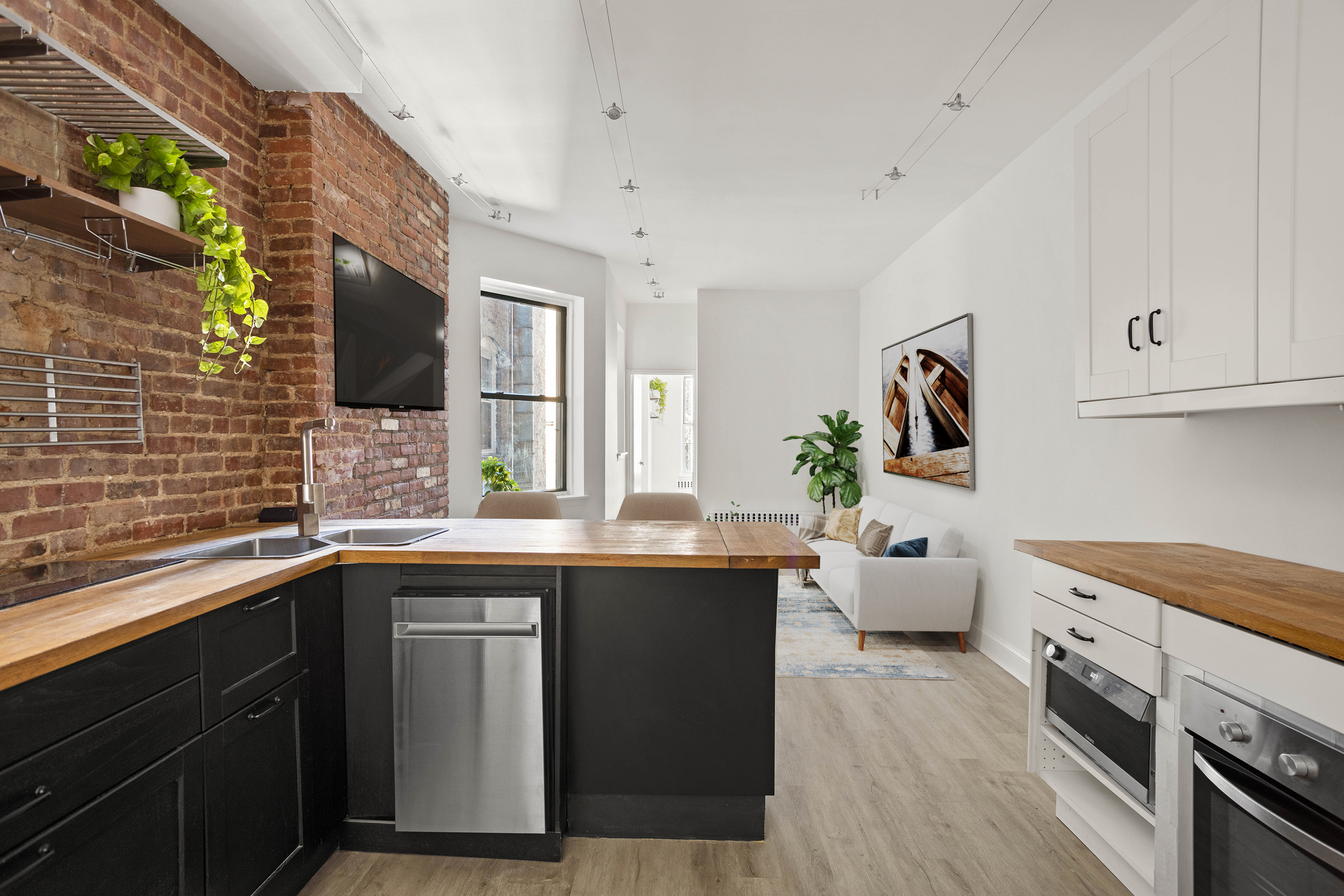 519 East 87th Street, Unit 2C Manhattan, NY 10128 - Photo 2 of 6 a kitchen with a sink and cabinets