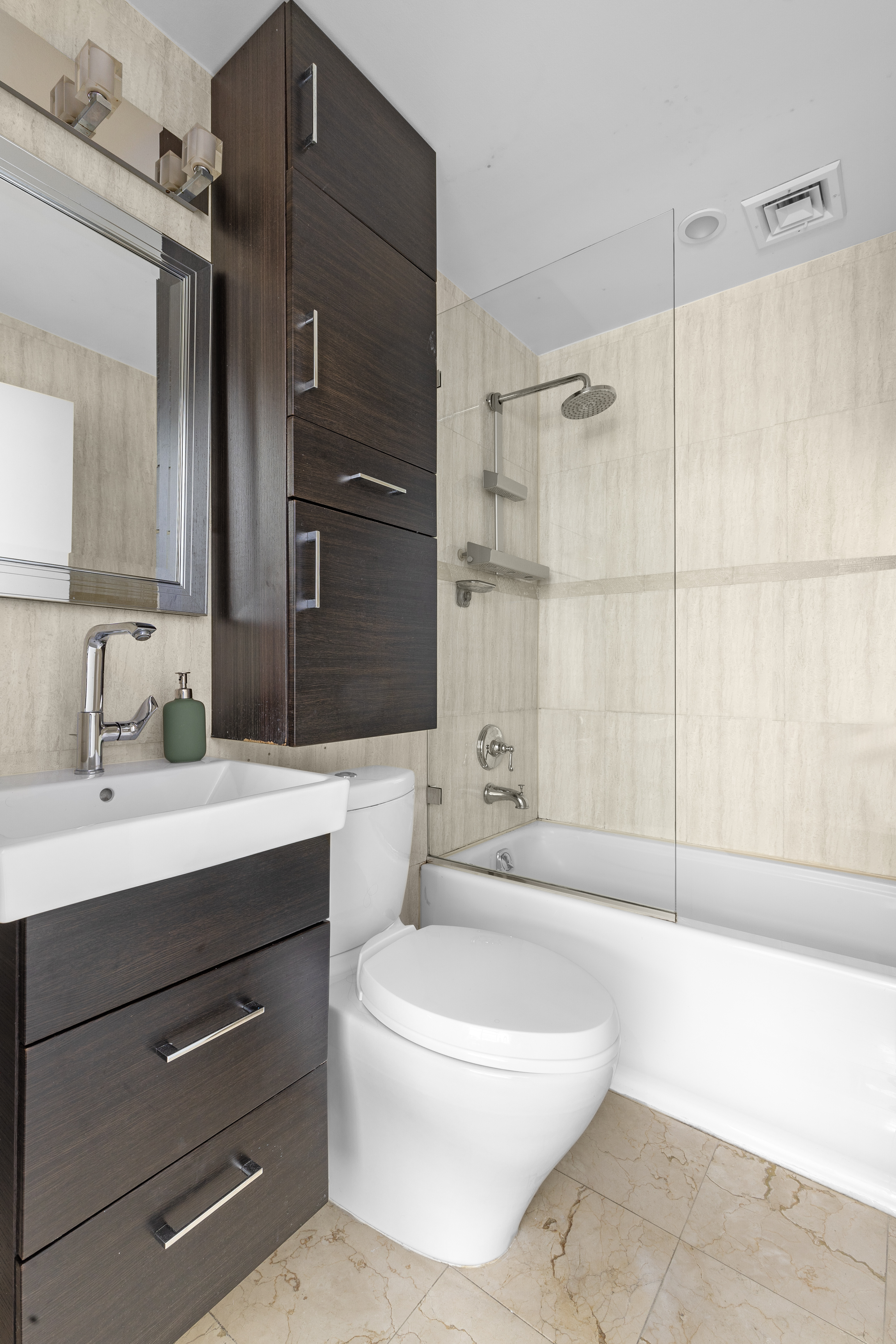 372 5th Avenue, Unit 5F Manhattan, NY 10018 - Photo 5 of 9 a bathroom with a sink a toilet and shower