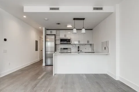 a kitchen with stainless steel appliances a refrigerator sink and microwave