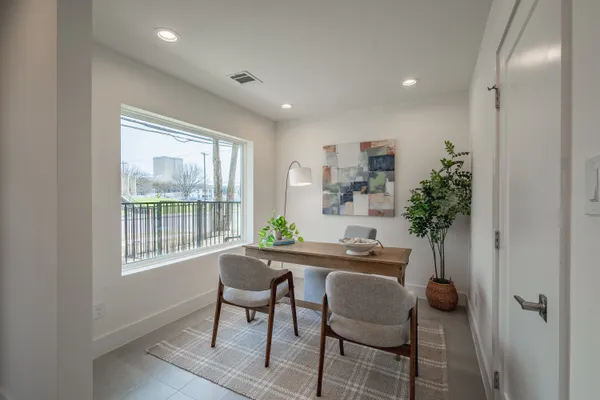 a dining room with furniture and potted plant