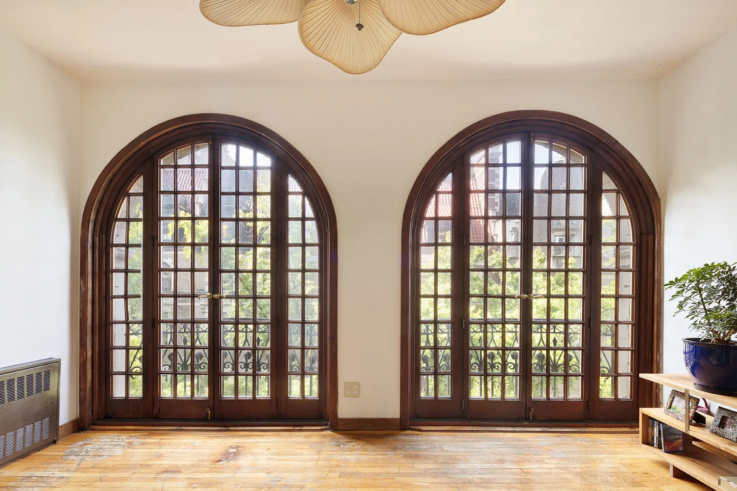 a view of a balcony with chairs and wooden floor