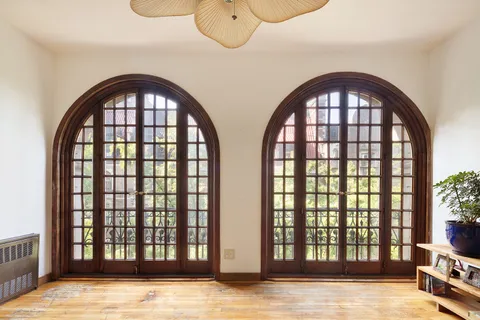 a view of a balcony with chairs and wooden floor