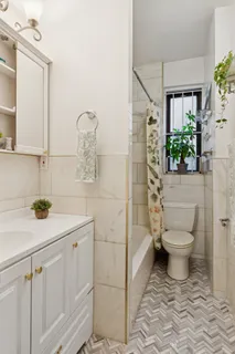 a bathroom with a toilet sink and shower