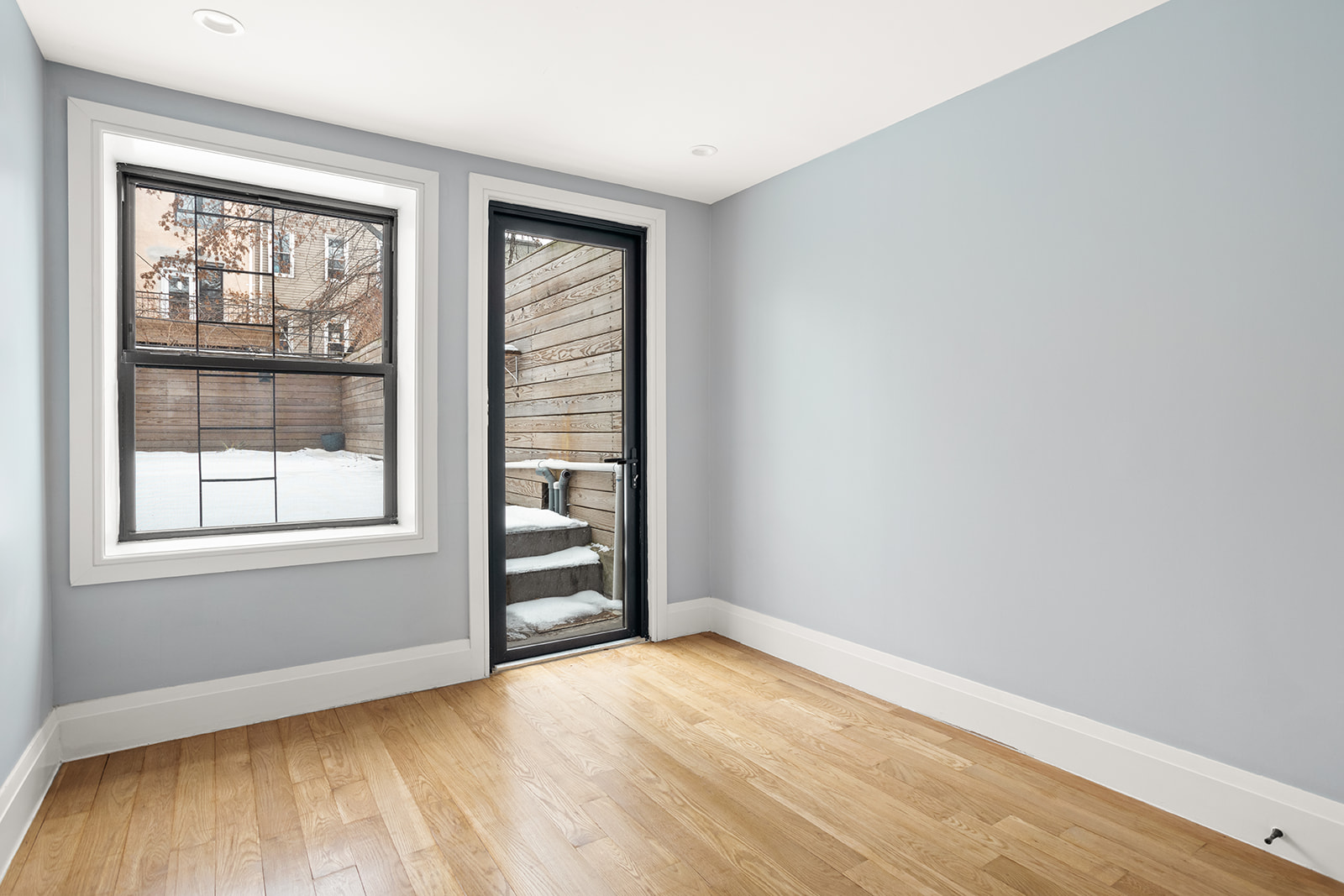 1183 Jefferson Avenue, Unit 1 Brooklyn, NY 11221 - Photo 6 of 11 an empty room with wooden floor and windows