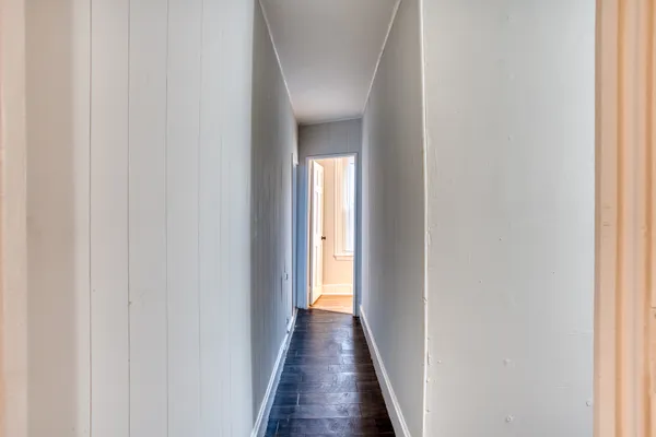 a view of a hallway with wooden floor