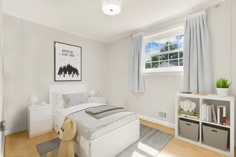 a bedroom with a bed and a window