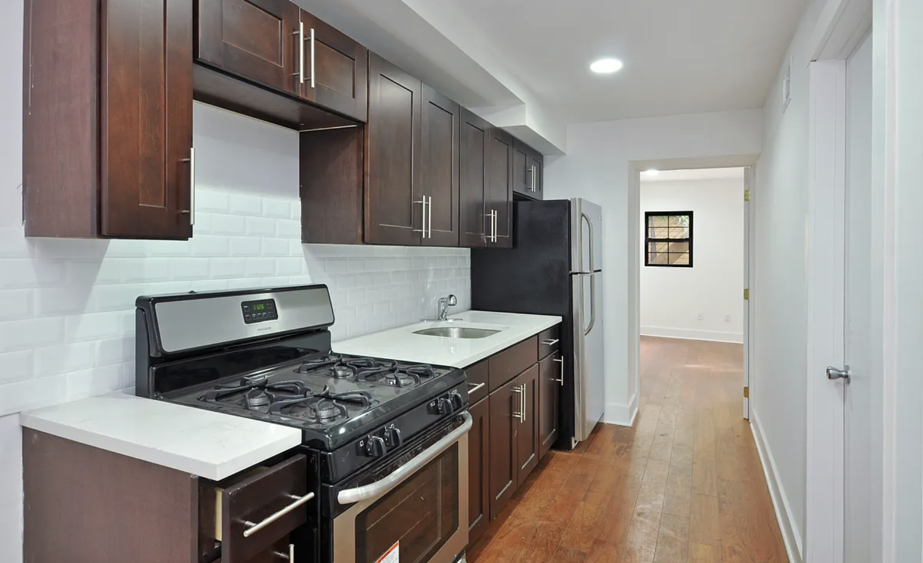 698 Halsey Street Brooklyn, NY 11233 - Photo 9 of 13 a kitchen with a stove and a refrigerator