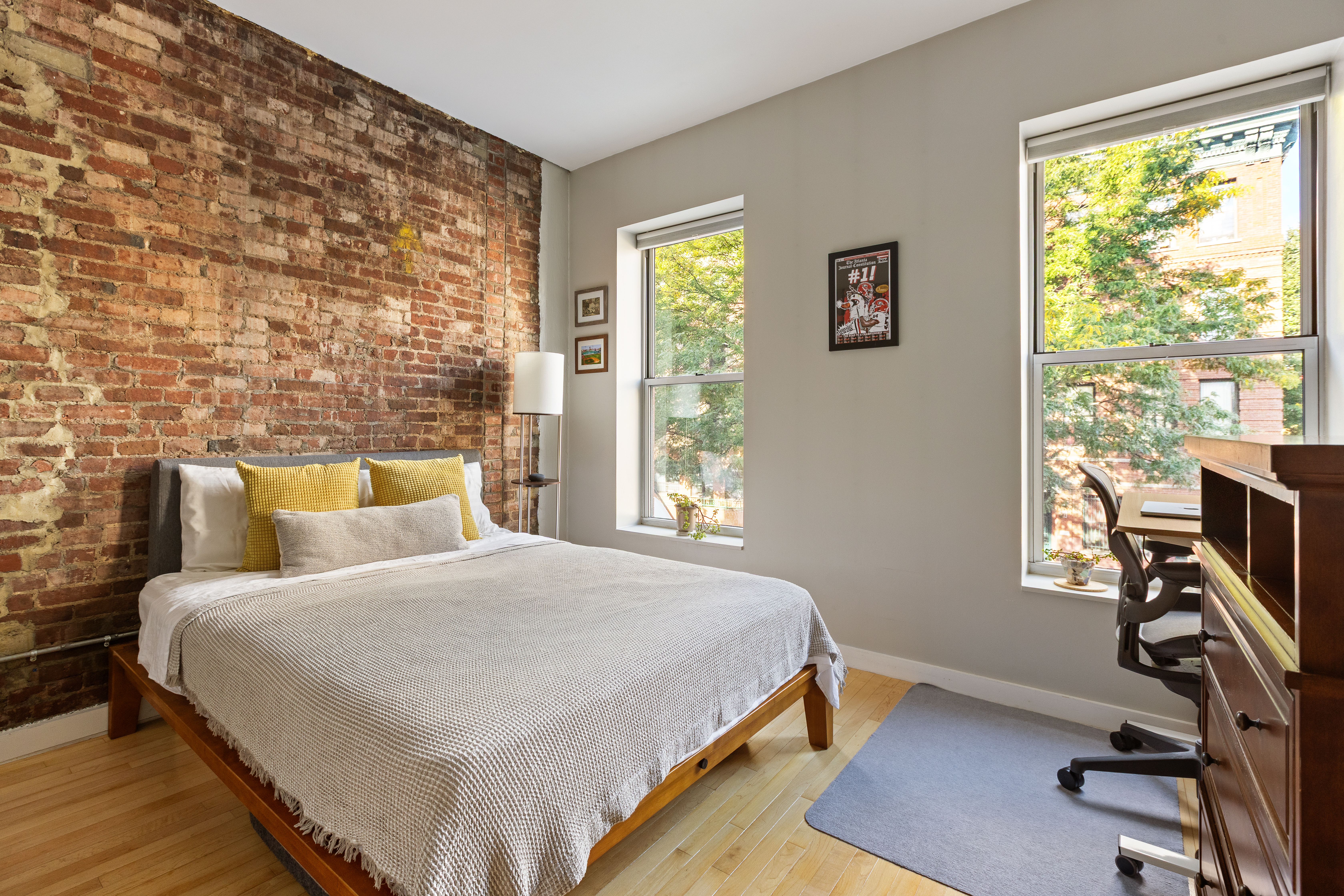 524 St Johns Place, Unit 2A Brooklyn, NY 11238 - Photo 4 of 8 a bedroom with a bed a computer on the desk and a large window