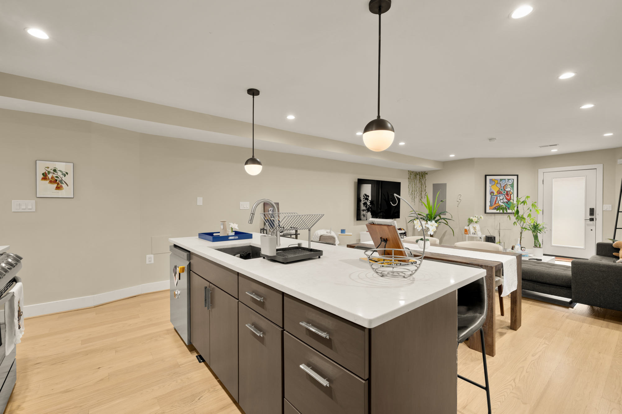 14 T Street Northeast, Unit 1 Washington, DC 20002 - Photo 19 of 39 a kitchen with a sink a stove and chairs with wooden floor