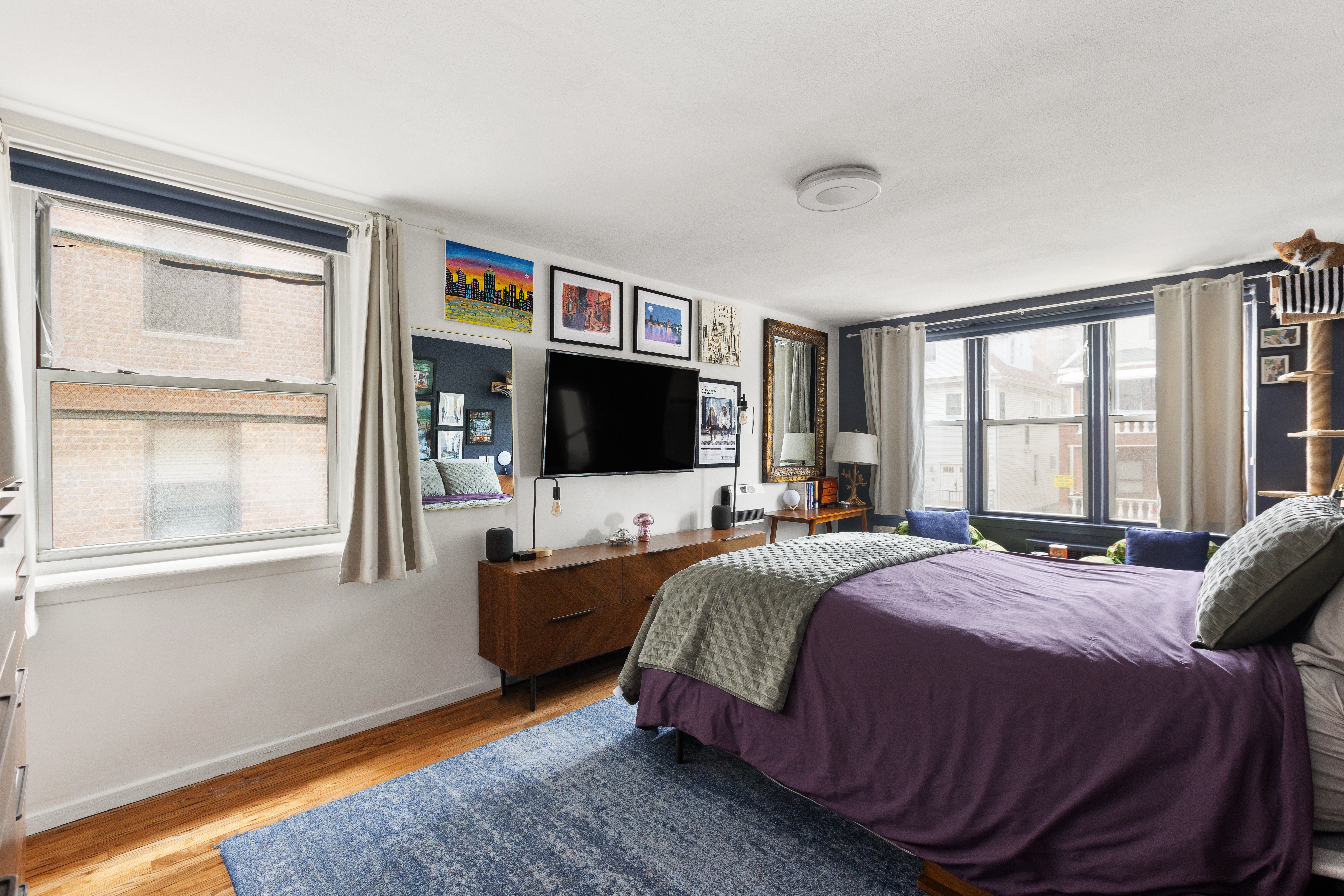 495 East 7th Street, Unit 2F Brooklyn, NY 11218 - Photo 5 of 10 a bedroom with a bed and a flat screen tv