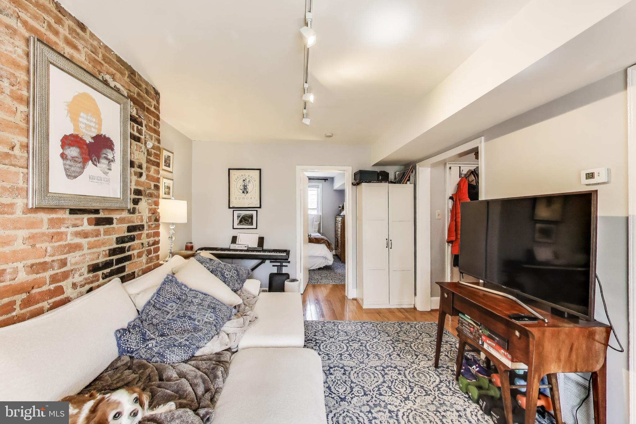 1317 Corcoran Street Northwest Washington, DC 20009 - Photo 20 of 47 a living room with furniture and a flat screen tv