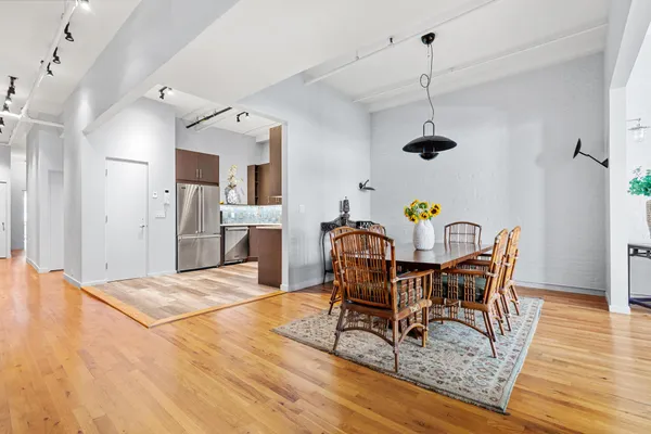 a dining room with furniture and wooden floor