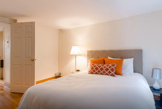 162 Christopher Street, Unit TH4 Manhattan, NY 10014 - Photo 3 of 5 a bedroom with a bed and a lamp