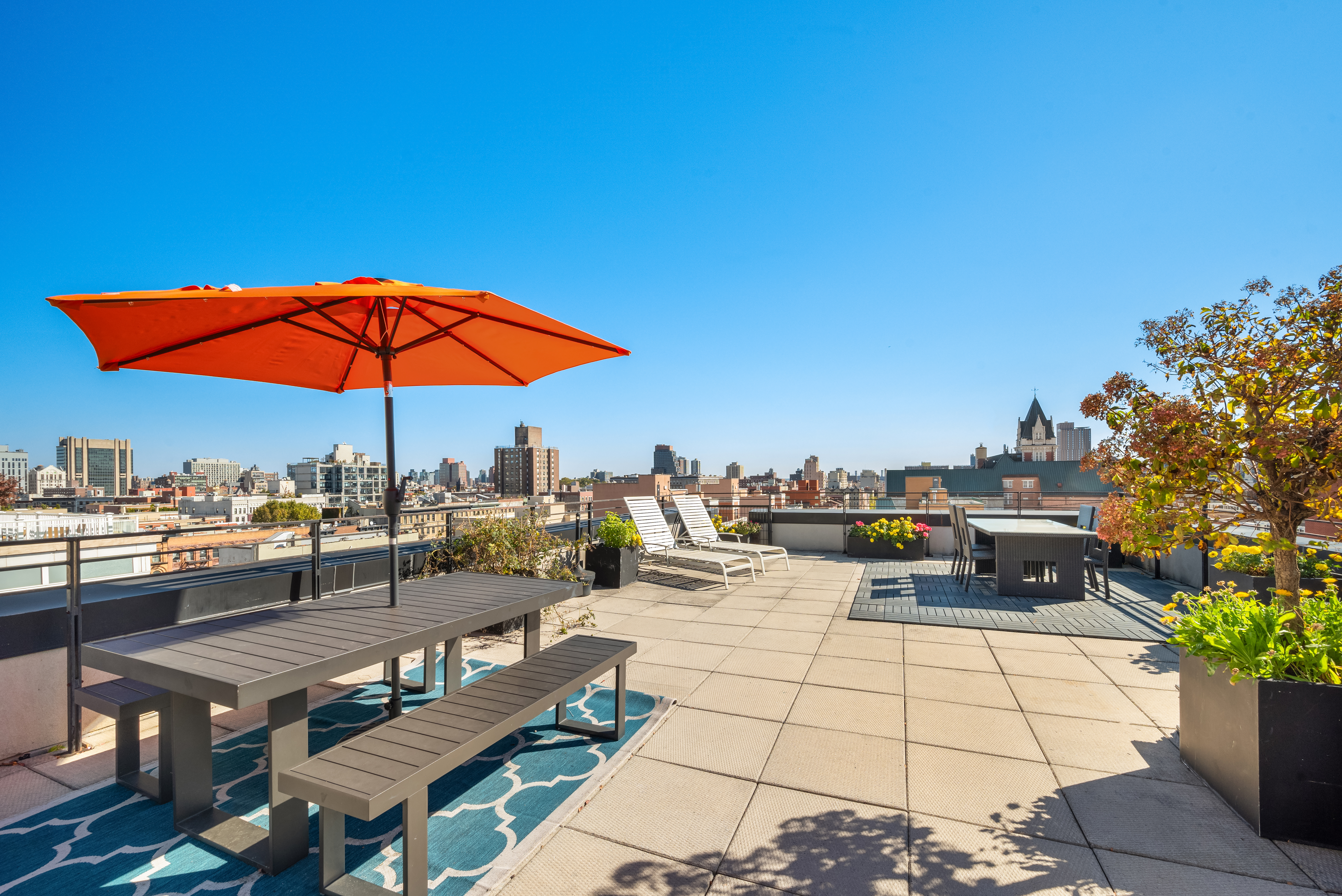 304 West 115th Street, Unit 6A Manhattan, NY 10026 - Photo 11 of 14 a view of a terrace with furniture and umbrella