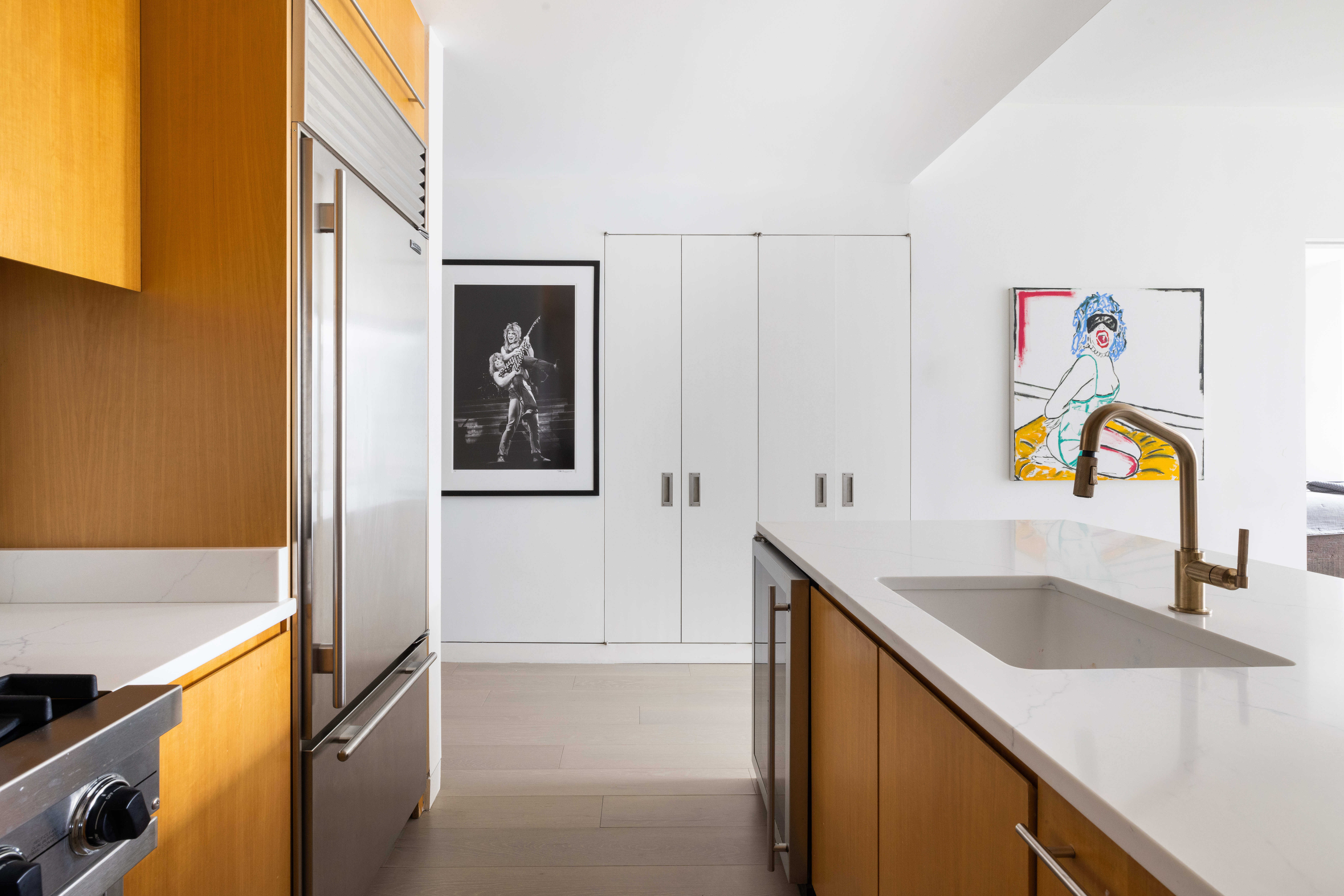 255 Hudson Street, Unit 9C Manhattan, NY 10013 - Photo 7 of 19 a kitchen with a sink and a refrigerator