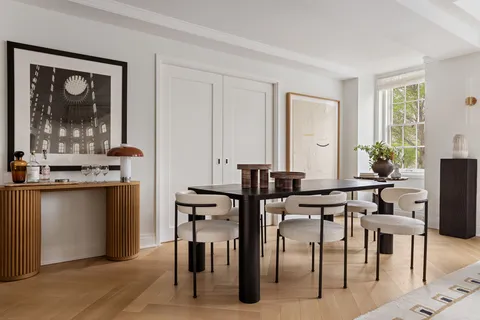 a view of a dining room with furniture and window