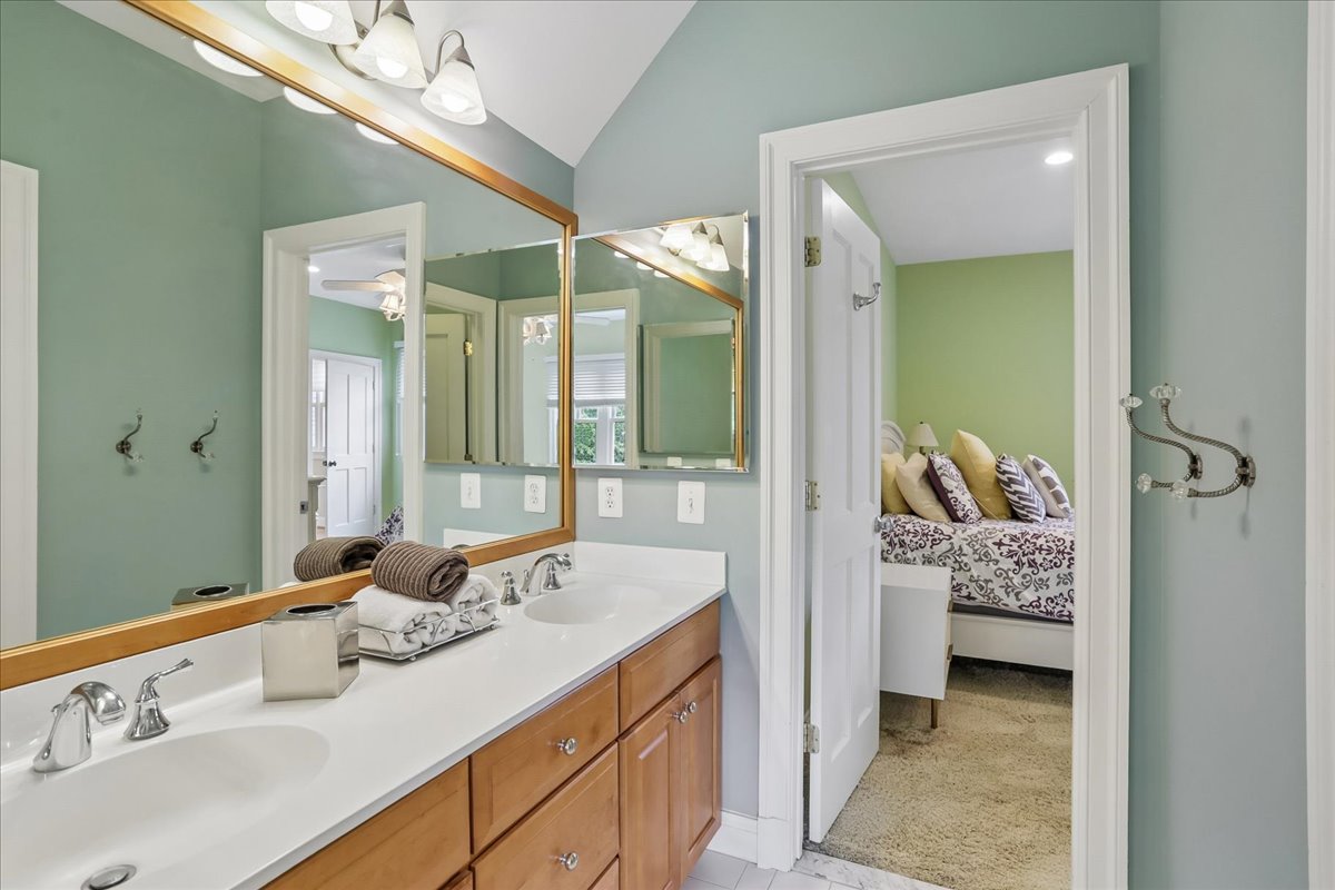 11736 Gainsborough Road Potomac, MD 20854 - Photo 76 of 90 a en suite bathroom with a double vanity sink a large mirror and a shower