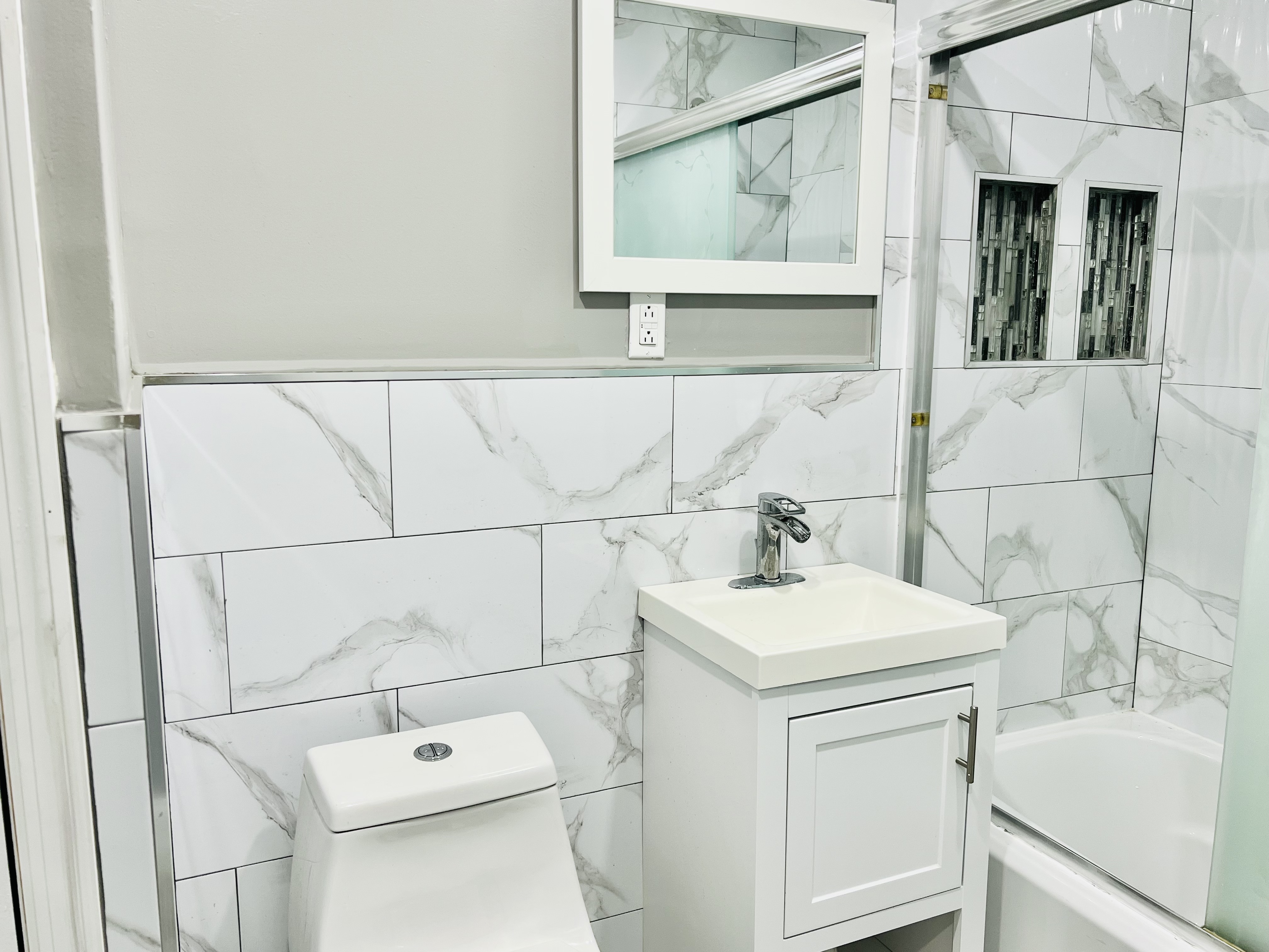 194 Pulaski Street, Unit 1 Brooklyn, NY 11206 - Photo 4 of 6 a bathroom with a sink and a toilet