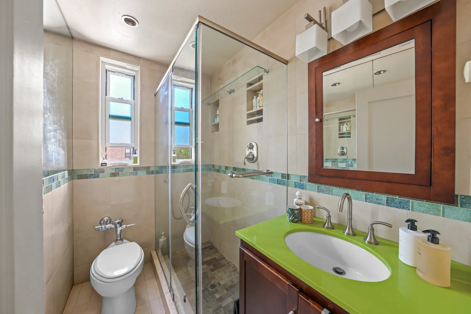 a bathroom with a granite countertop sink and a mirror