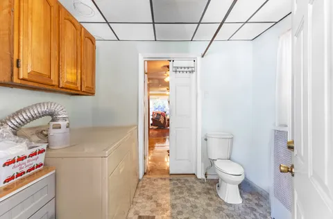 a white toilet sitting next to a bathroom sink