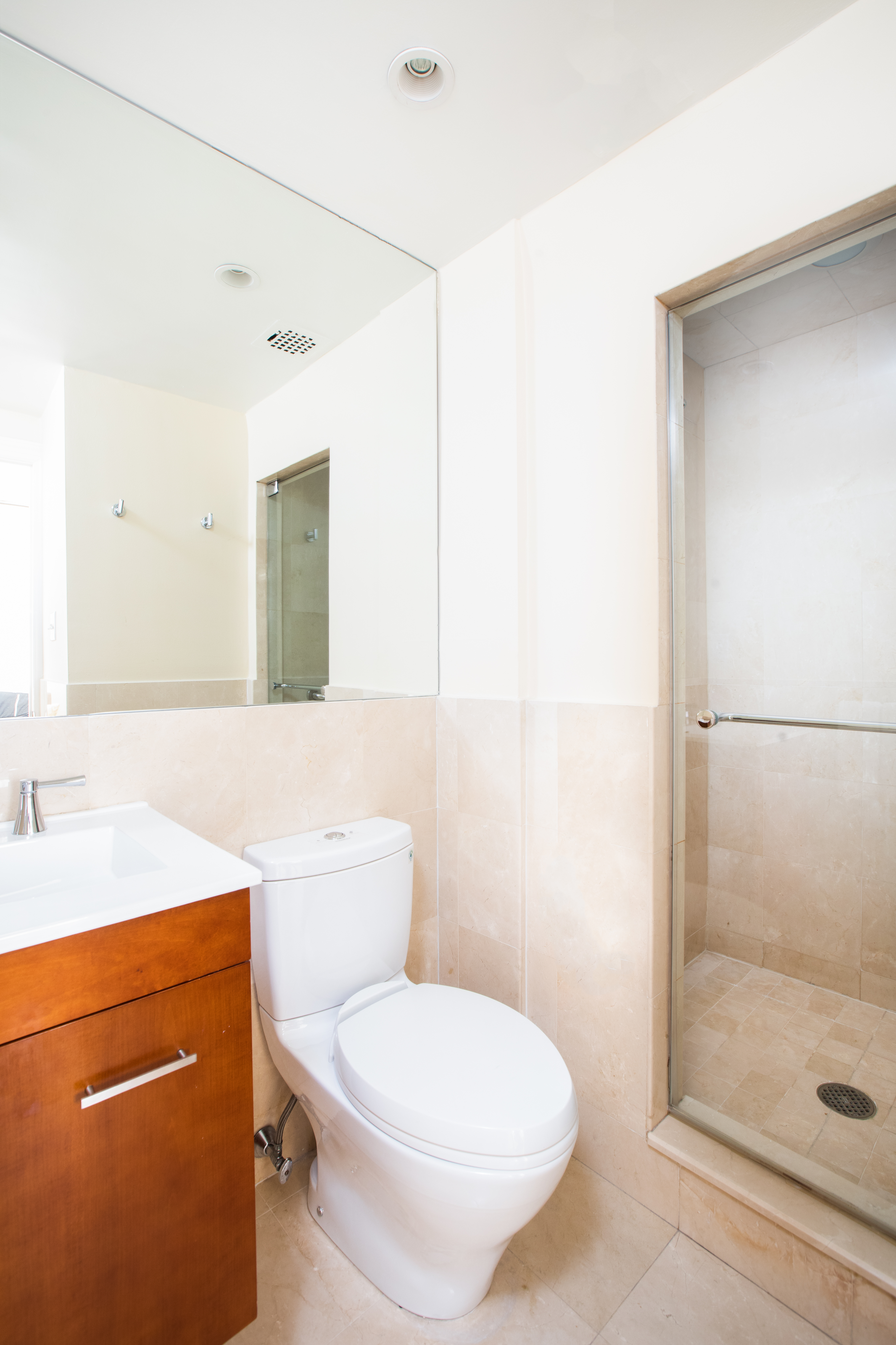 111 East 56th Street, Unit 1705 Manhattan, NY 10022 - Photo 5 of 12 a bathroom with a toilet a sink and shower