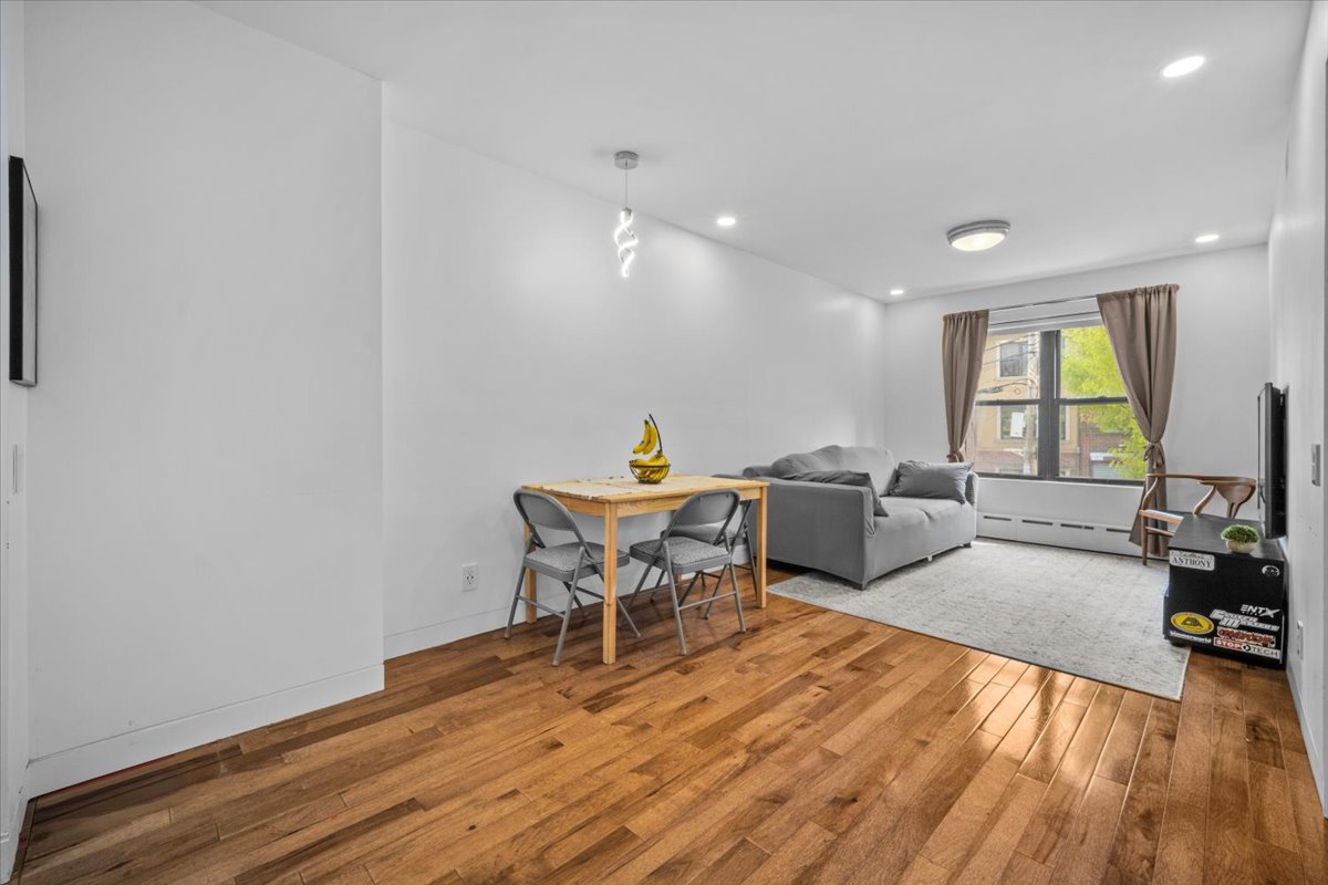1477 Prospect Place, Unit 2 Brooklyn, NY 11213 - Photo 3 of 14 a living room with furniture and a wooden floor