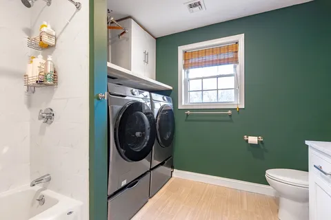 a bathroom with a sink a toilet and a shower