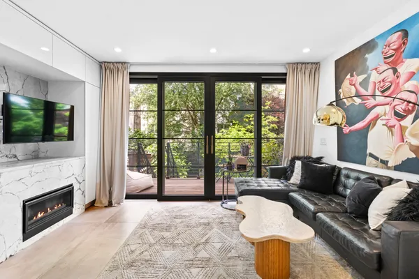 a living room with furniture a fireplace and a flat screen tv