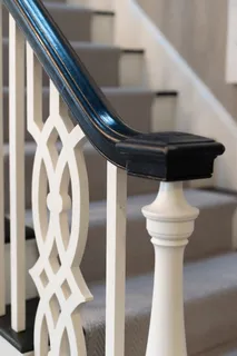 a living room with furniture a large window and wooden floor
