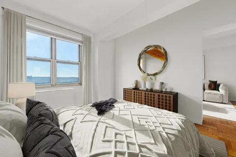 a bedroom with a large bed and a window