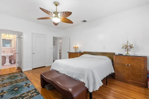 a bedroom with a bed and wooden floor