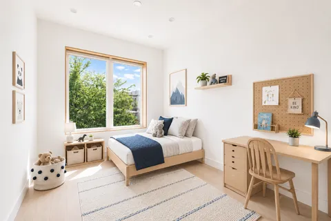 a bedroom with a bed and a chair