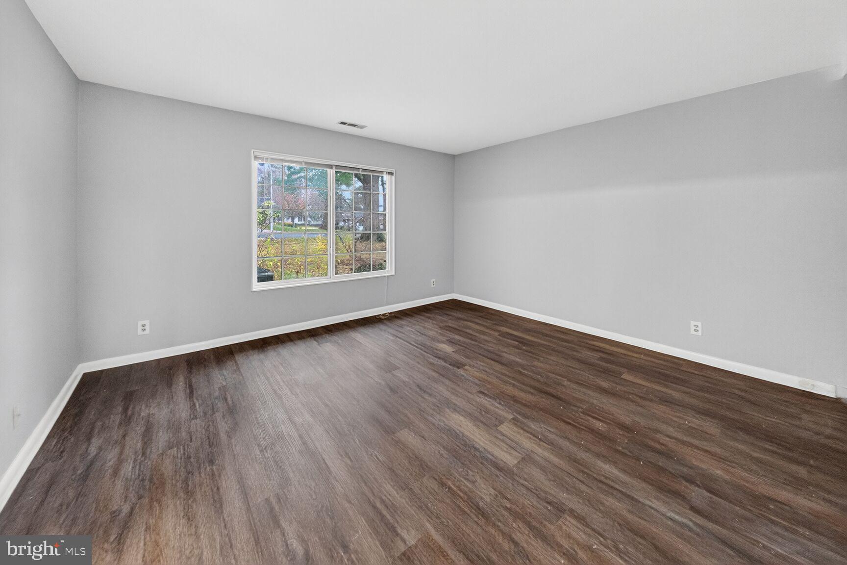 14603 Edelmar Drive, Unit 132A Silver Spring, MD 20906 - Photo 29 of 52 a view of an empty room with wooden floor and a window