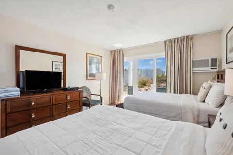 a bedroom with a bed and a flat screen tv