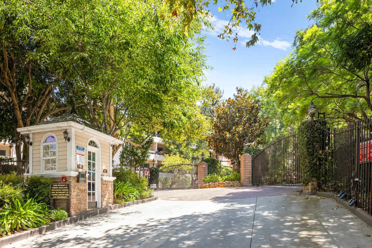 a view of a white house with a tree