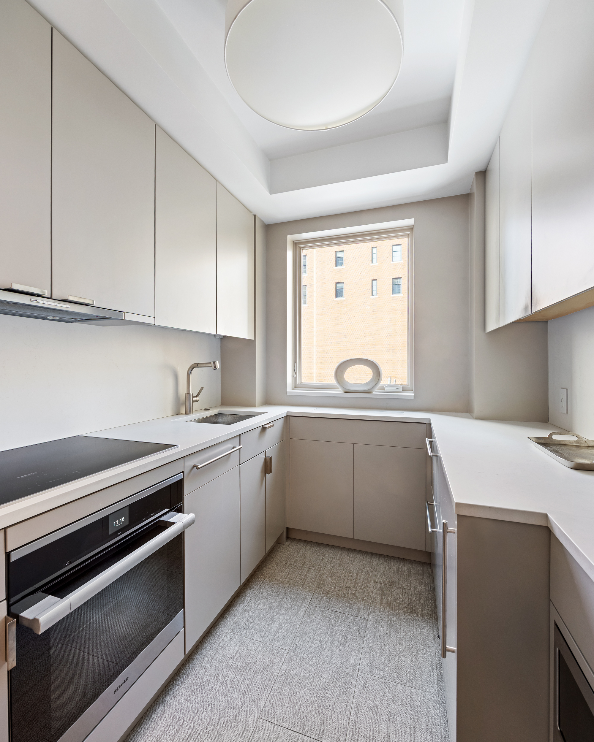 169 East 78th Street, Unit 7C Manhattan, NY 10075 - Photo 16 of 30 a kitchen that has a sink and a stove