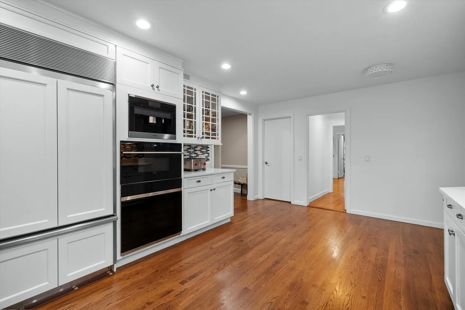 a kitchen with stainless steel appliances a refrigerator and a stove top oven
