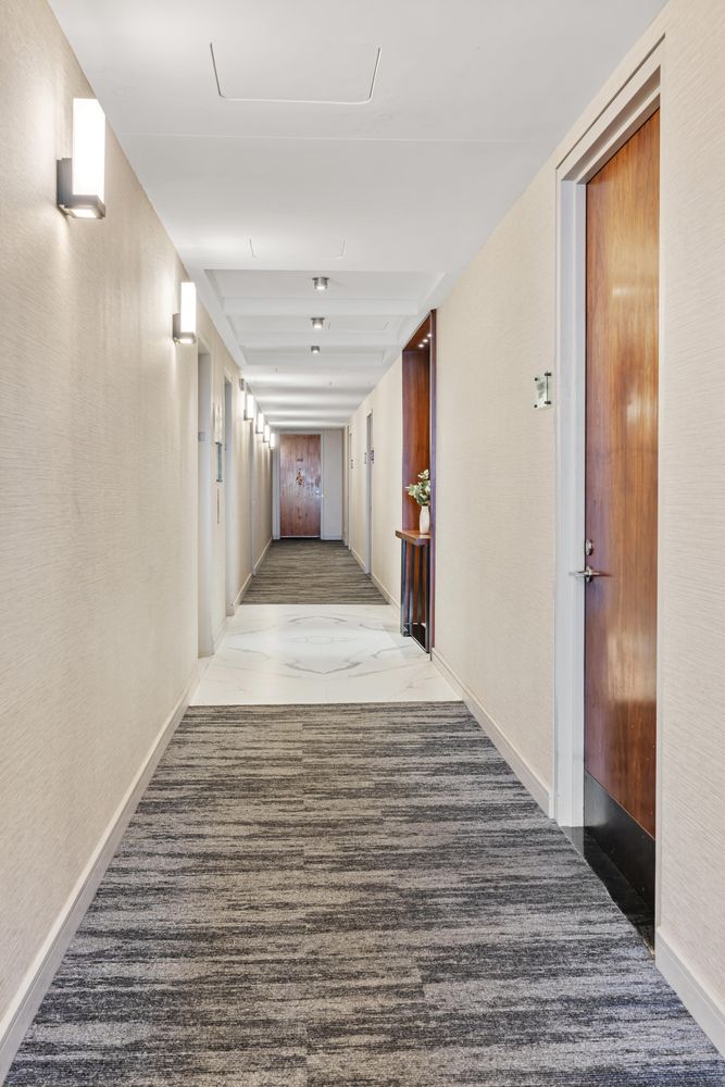 a view of a hallway with wooden floor